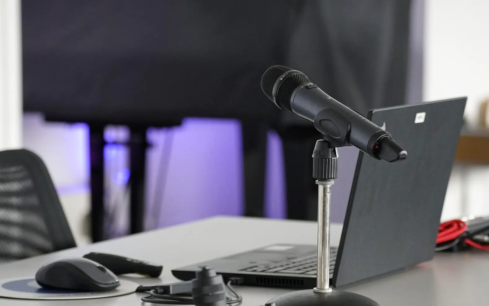 Laptop, conference table and mouse